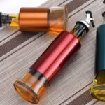 Glass Oil Dispenser with Plastic Covering, Oil and Vinegar Bottle (300 ml) - Sleeve Design by Nari Haat, Indian ethni...