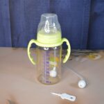 Plastic Baby Feeding Bottle with Handles, Cleaning brush & Straw (300 ML / 1 Pc) - Back View by Nari Haat, Indian eth...