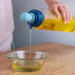 2 in 1 Transparent Oil Dispenser with Silicone Oil Dropper Nozzle (1 Pc / With Brush / 1 Ltr) - Back View by Nari Haa...