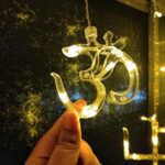 Swastik Om Curtain Decorative LED String Lights with 12 Props for Diwali & Home - Neckline Detail by Nari Haat, India...