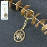 Maa Durga Oval Frame Golden Keychain (1 Pc) - Front View by Nari Haat, Indian ethnic wear, women clothing, designer suit