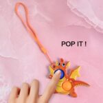 2-Bubble Dragon-Shaped Push Pop Fidget Toy with Strap (1 Pc) - Closeup Embroidery by Nari Haat, Indian ethnic wear, w...