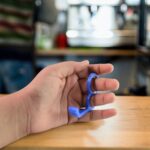 Plastic Hand Mobile Stand (Mix Color / 1 Pc) - Closeup Embroidery by Nari Haat, Indian ethnic wear, women clothing, d...