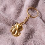 Golden Ganesh Leaf Design Keychain (1 Pc) - Neckline Detail by Nari Haat, Indian ethnic wear, women clothing, designe...