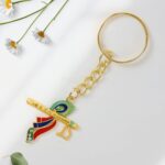 Krishna Flute with Peacock Feather Design Keychain (1 Pc) - Neckline Detail by Nari Haat, Indian ethnic wear, women c...