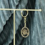 Maa Durga Oval Frame Golden Keychain (1 Pc) - Neckline Detail by Nari Haat, Indian ethnic wear, women clothing, desig...