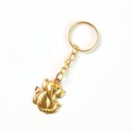 Golden Ganesh Leaf Design Keychain (1 Pc) - Sleeve Design by Nari Haat, Indian ethnic wear, women clothing, designer ...