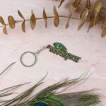 “Jai Shree Krishna” Text Metal Keychain (1 Pc) - Fabric Detail by Nari Haat, Indian ethnic wear, women clothing, ...