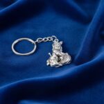 Premium Silver-Finish Metal Bal Krishna Eating Makhan Keychain (1 Pc) - Neckline Detail by Nari Haat, Indian ethnic w...