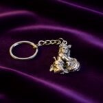 Premium Silver-Finish Metal Bal Krishna Eating Makhan Keychain (1 Pc) - Closeup Embroidery by Nari Haat, Indian ethni...