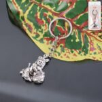 Premium Silver-Finish Metal Bal Krishna Eating Makhan Keychain (1 Pc) - Front View by Nari Haat, Indian ethnic wear, ...