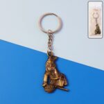 Premium Antique-Gold Metal Bal Krishna Makhan Chor Keychain (1 Pc) - Front View by Nari Haat, Indian ethnic wear, wom...