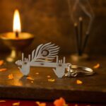 Krishna Flute & Peacock Feather Metal Keychain - (1 Pc) - Back View by Nari Haat, Indian ethnic wear, women clothing,...