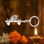 Krishna Flute & Peacock Feather Metal Keychain - (1 Pc) - Neckline Detail by Nari Haat, Indian ethnic wear, women clo...