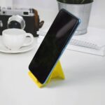 Adjustable Foldable Plastic Mobile Phone Stand (1 Pc / Mix Color) - Full Detail by Nari Haat, Indian ethnic wear, wom...
