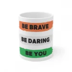 White ceramic coffee mug with 'Be Brave Be Daring Be You' quote