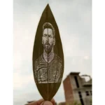 Engraved football player portrait on a natural leaf