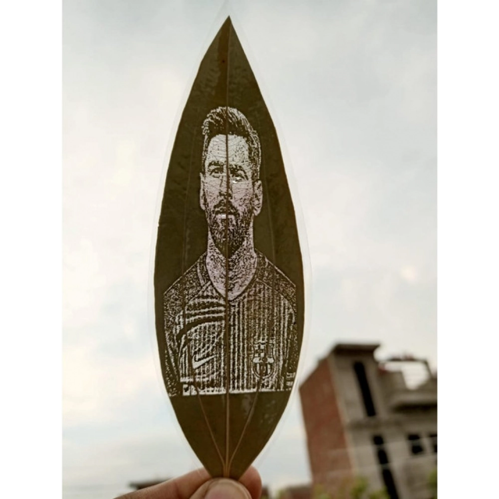 Engraved football player portrait on a natural leaf